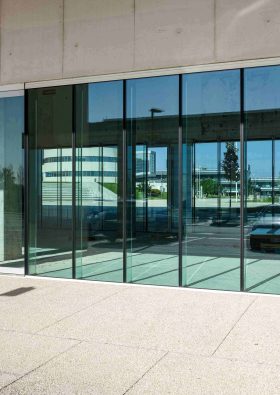 vertical-shot-transparent-doors-commercial-building (1)